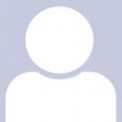 Placeholder photo of white circle above a shape that has rounded edges on the top to represent shoulders and a body. 